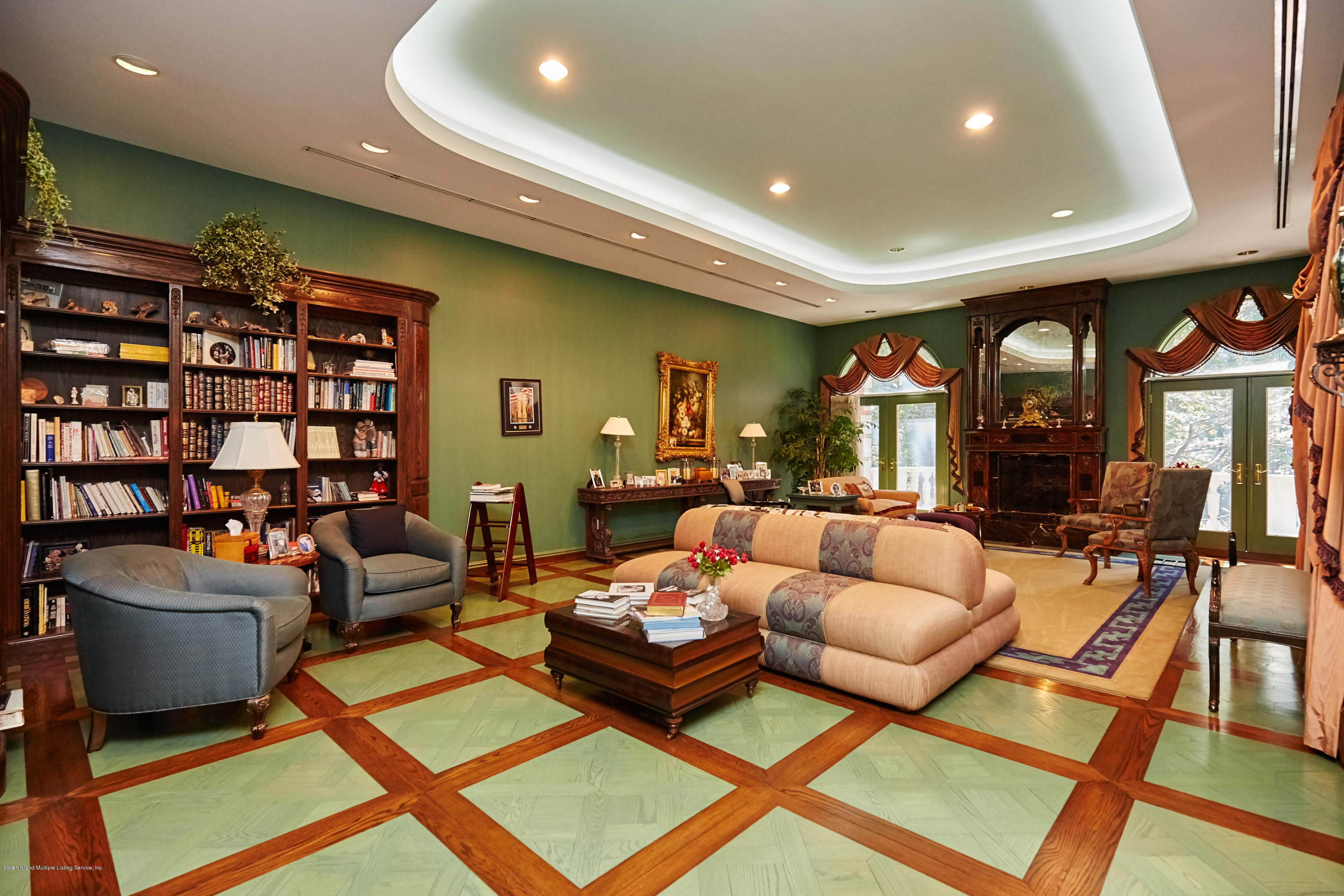 95 Circle Road Staten Island, NY 10304 - Photo 20 of 42 a living room with furniture a rug and a bookshelf