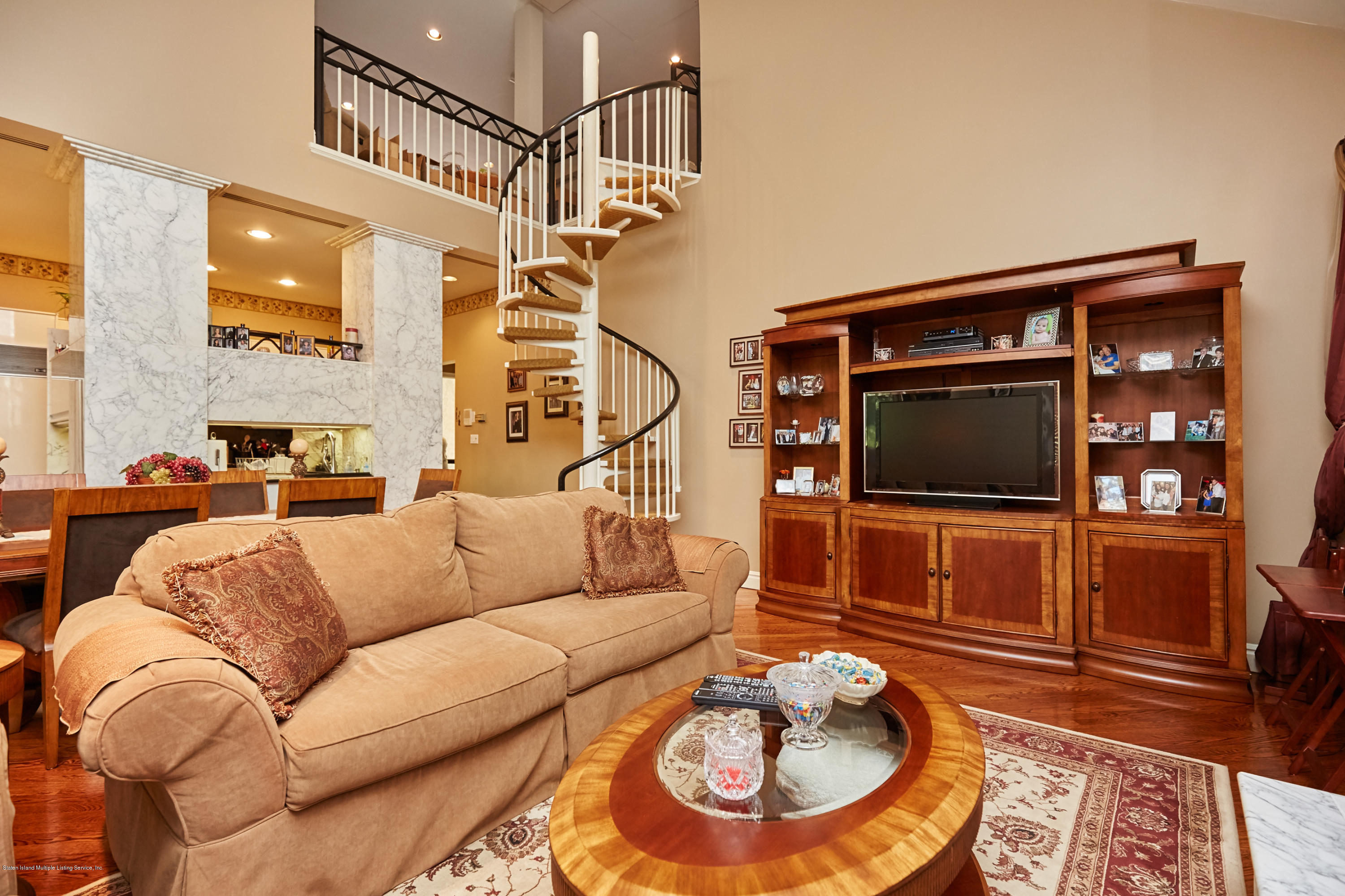 95 Circle Road Staten Island, NY 10304 - Photo 27 of 42 a living room with furniture and a fireplace