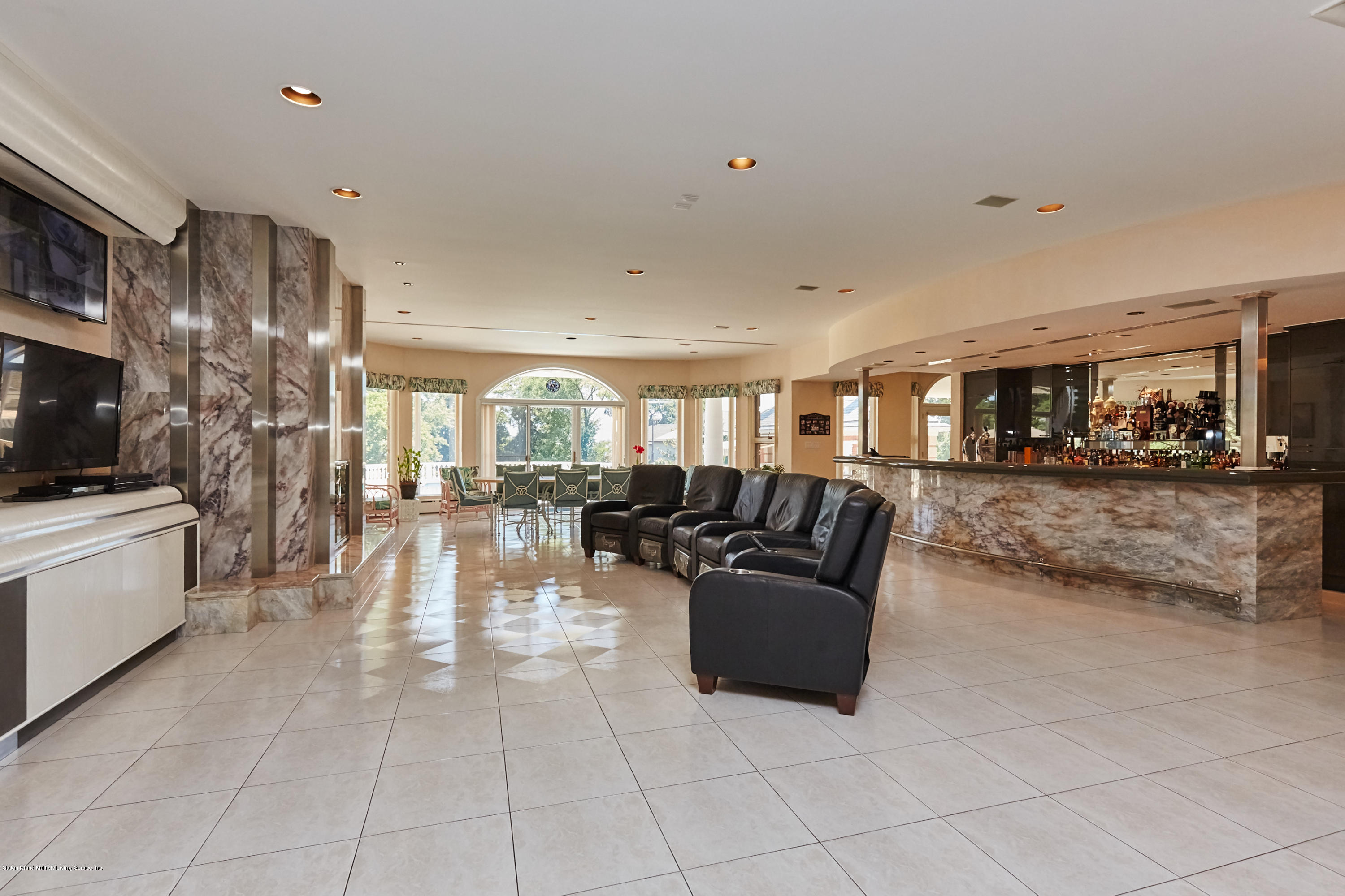 95 Circle Road Staten Island, NY 10304 - Photo 30 of 42 a living room with couches and kitchen view