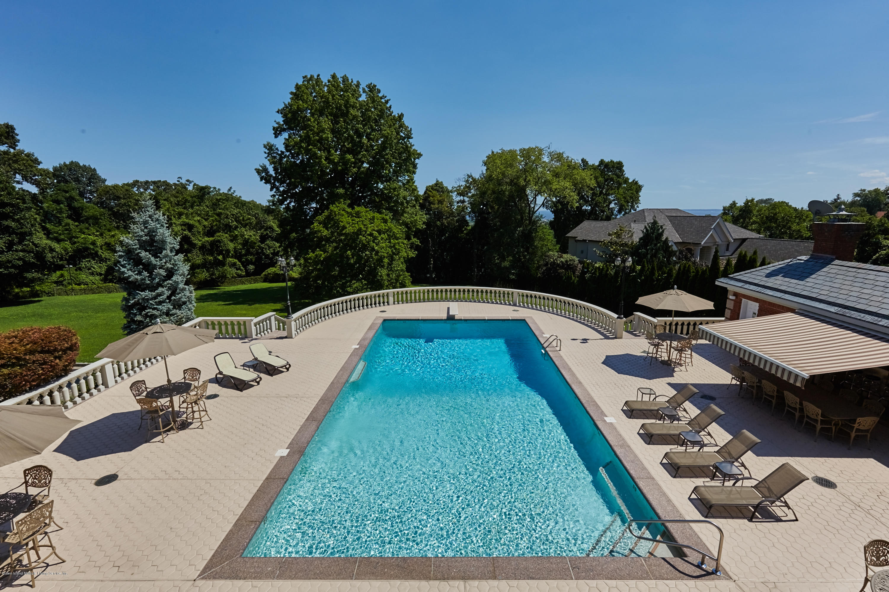 95 Circle Road Staten Island, NY 10304 - Photo 37 of 42 a view of a swimming pool with a yard and furniture