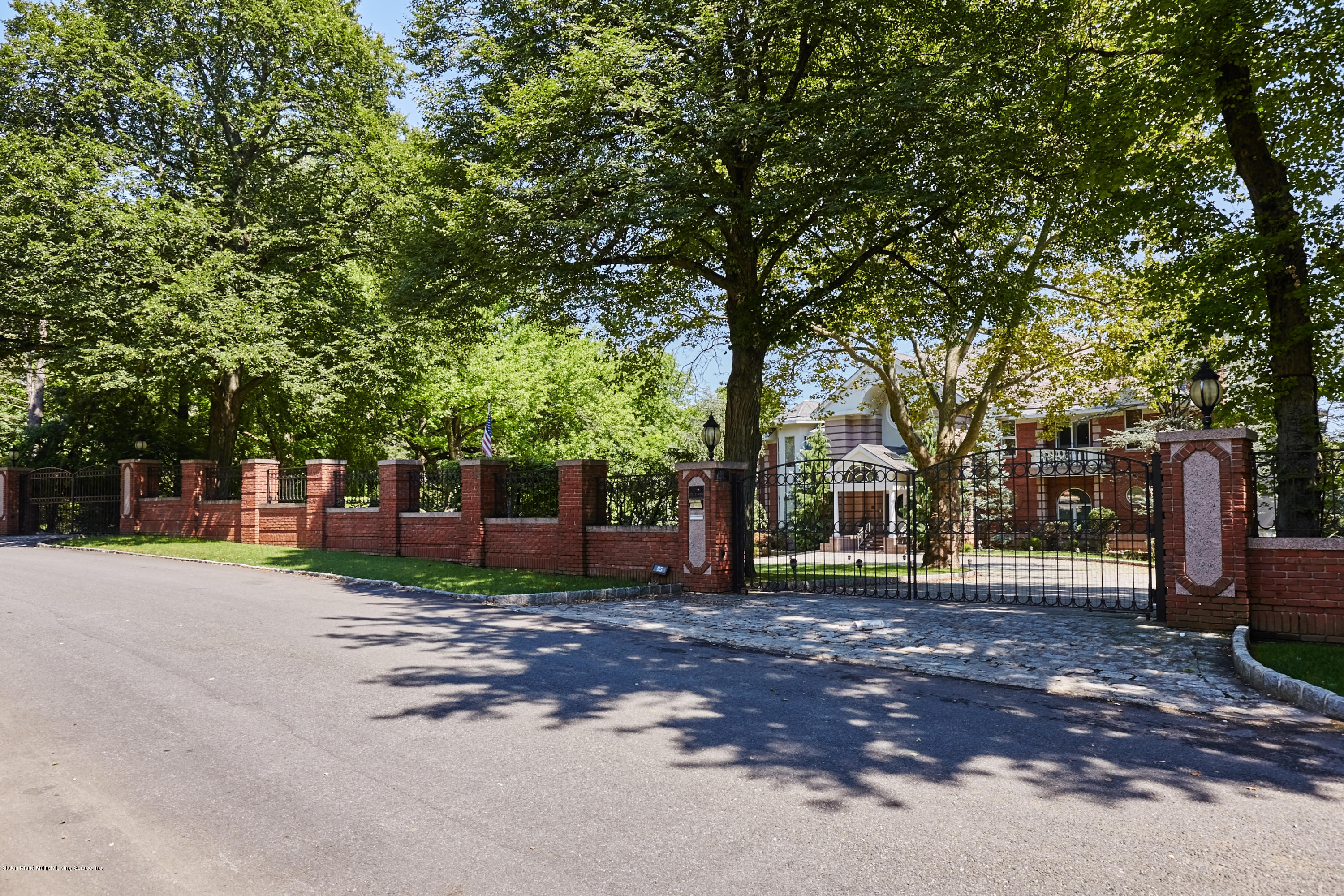 95 Circle Road Staten Island, NY 10304 - Photo 6 of 42 a front view of a house with a garden and trees
