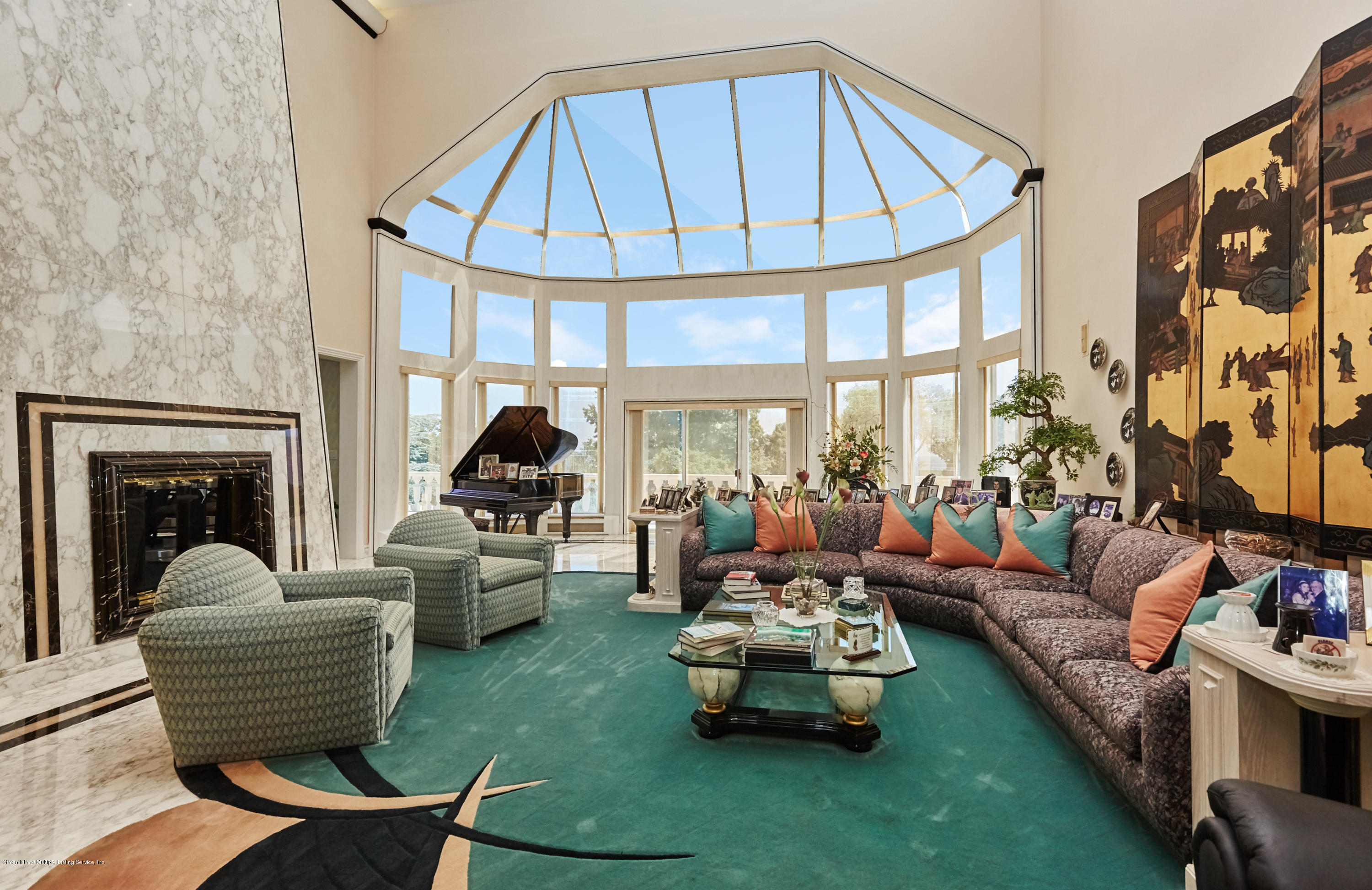 95 Circle Road Staten Island, NY 10304 - Photo 10 of 42 a living room with furniture a fireplace and large windows