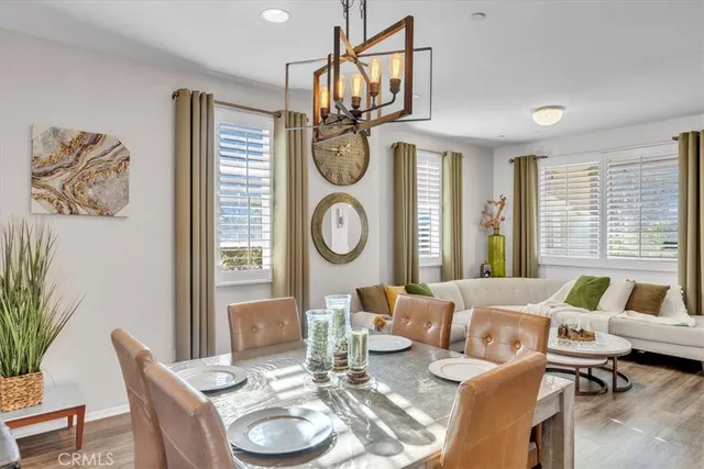 a living room with furniture a chandelier and a window