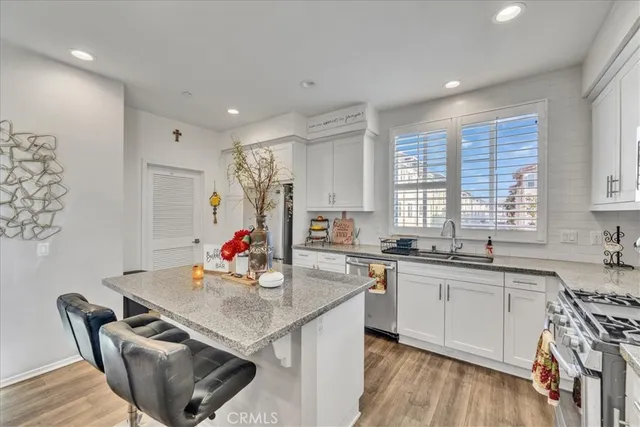 a kitchen with stainless steel appliances kitchen island granite countertop a sink and cabinets