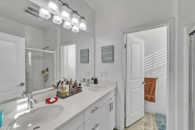 a bathroom with a sink vanity and mirror
