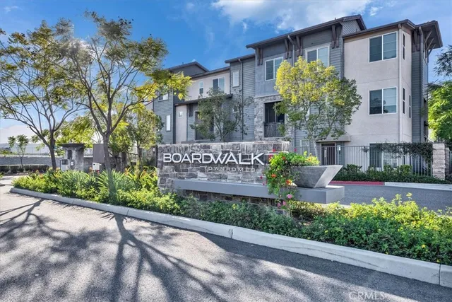 a front view of a house with a yard and fountain