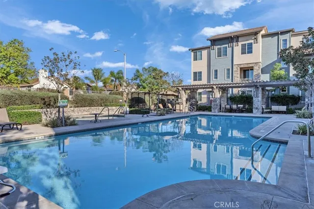 a view of swimming pool with outdoor seating and city view