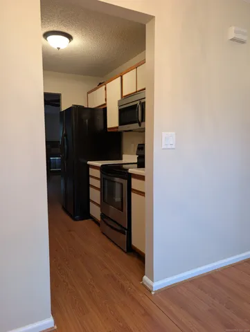 a kitchen with stainless steel appliances a refrigerator and a stove top oven
