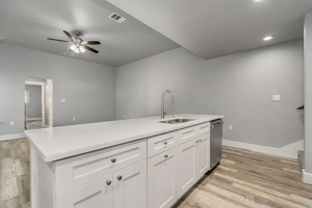 a kitchen with a sink dishwasher and a refrigerator
