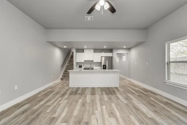 a view of kitchen with sink microwave and outdoor view
