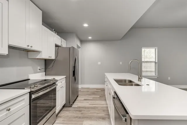 a kitchen that has a sink and a stove
