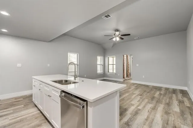 a view of kitchen with sink microwave and refrigerator