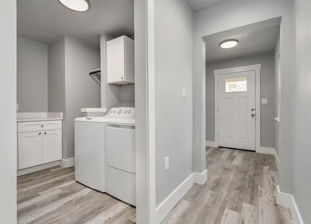 a view of a storage & utility room with a washer dryer