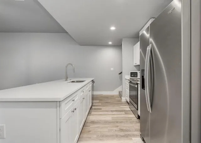 a kitchen with a sink and refrigerator