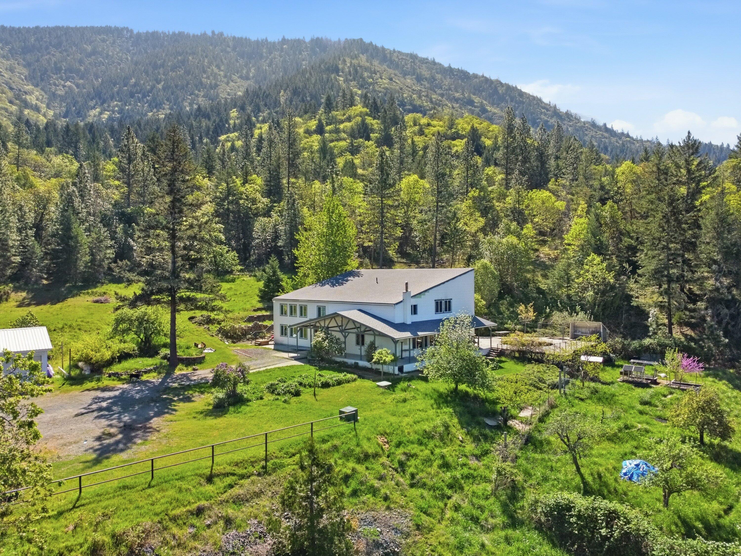 827 Summit Loop Grants Pass, OR 97527 - Photo 2 of 32 a view of a garden with mountain