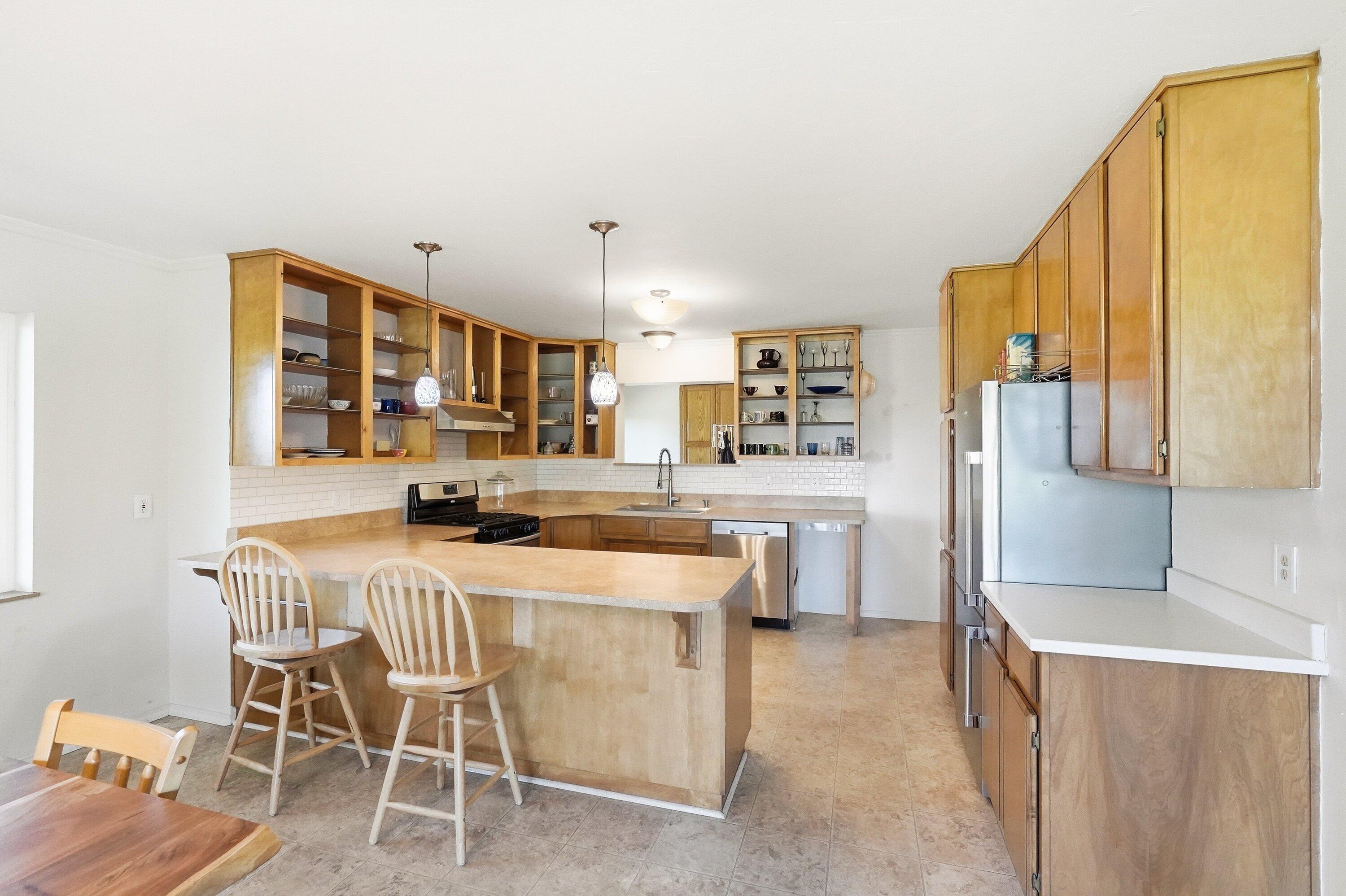827 Summit Loop Grants Pass, OR 97527 - Photo 6 of 32 a kitchen with a table chairs refrigerator and cabinets