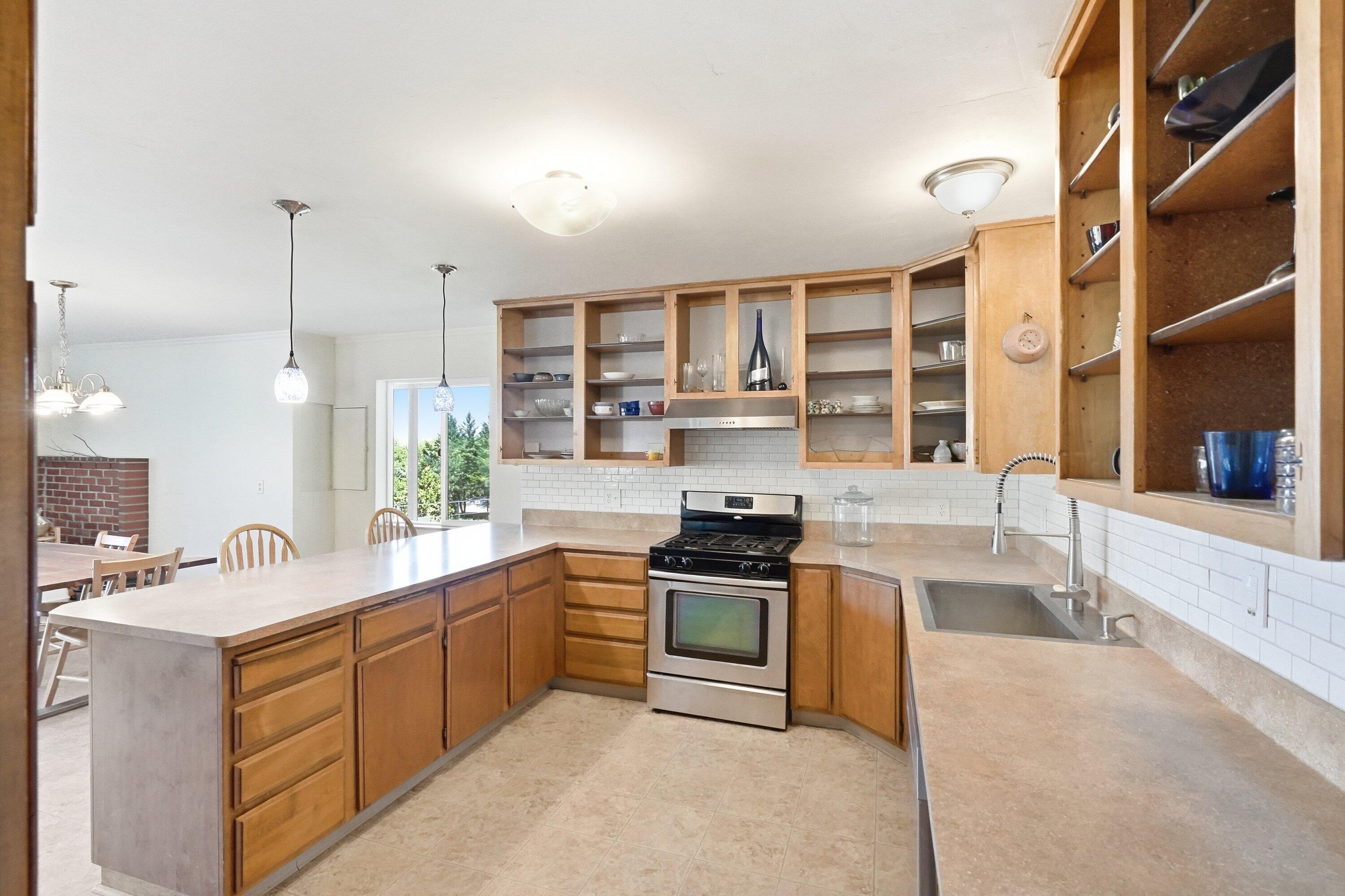827 Summit Loop Grants Pass, OR 97527 - Photo 7 of 32 a kitchen with a sink stove and cabinets