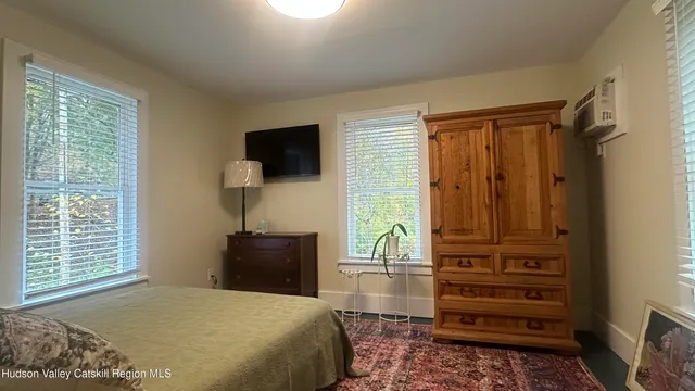 a bedroom with a bed and a television