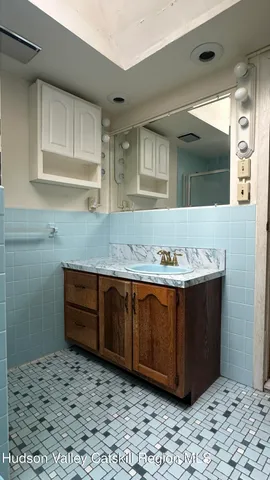 a bathroom with a sink and a mirror