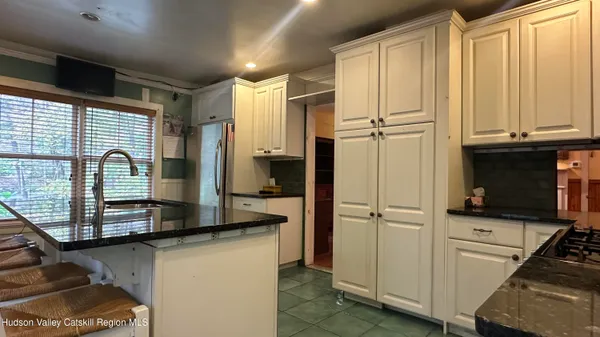 a kitchen with stainless steel appliances granite countertop a refrigerator and a sink