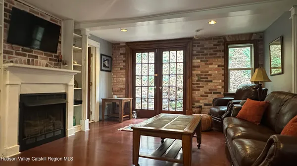 a living room with furniture a flat screen tv and a fireplace
