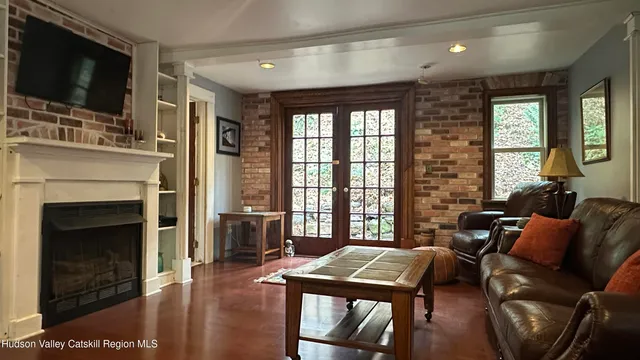 a living room with furniture a flat screen tv and a fireplace