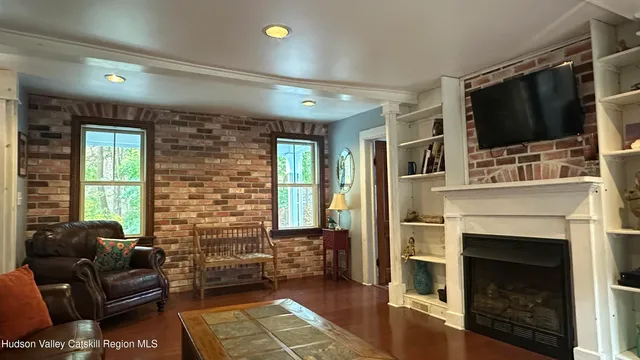 a living room with furniture a flat screen tv and a fireplace