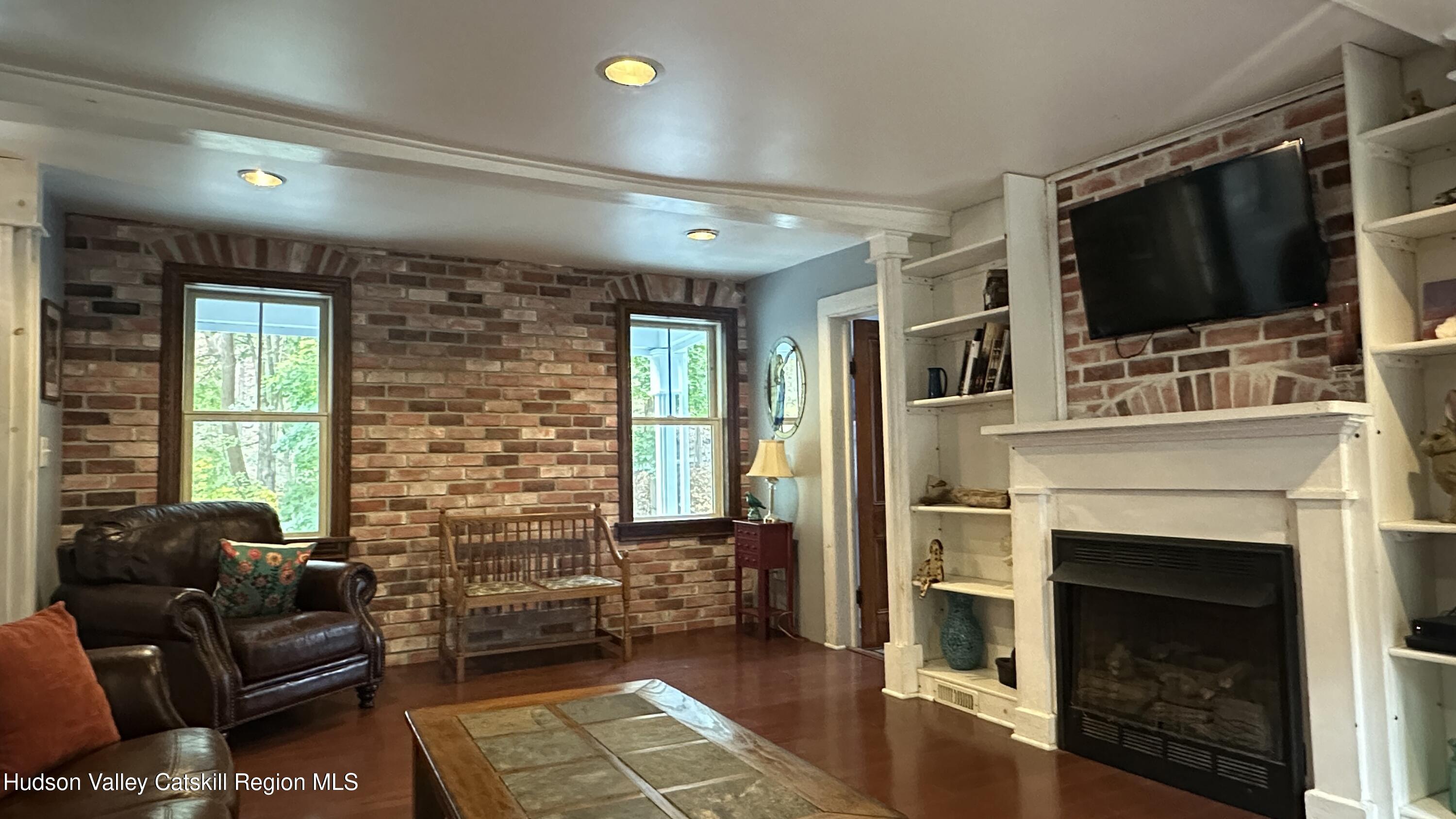 7 River Road, Unit TOWN ROAD Highland, NY 12528 - Photo 8 of 25 a living room with furniture a flat screen tv and a fireplace