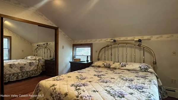 a bedroom with two bed and a dresser