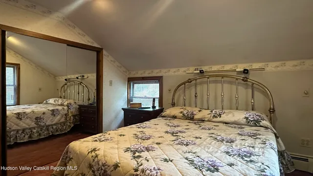 a bedroom with two bed and a dresser