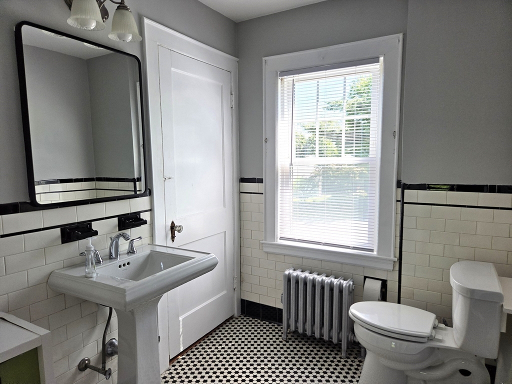 25 Waldeck Road Milton, MA 02186 - Photo 25 of 34 a bathroom with a sink a toilet and a mirror