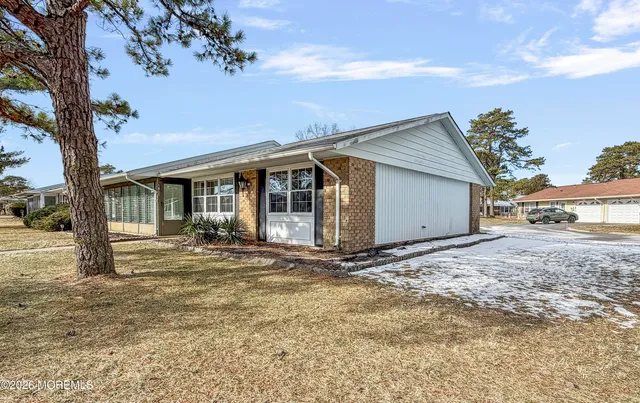 a view of a house with a tree in the background