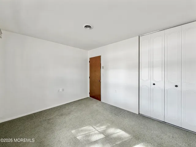a bathroom with a granite countertop sink toilet mirror and shower