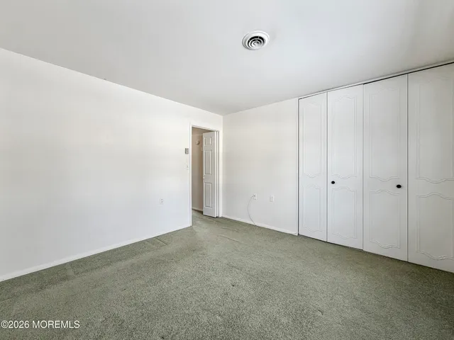 a view of a livingroom with wooden floor and a ceiling fan