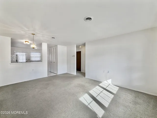 a kitchen with a refrigerator a stove top oven and a sink