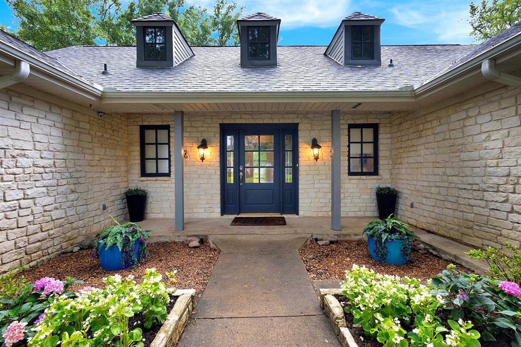103 Glenn Road Mabank, TX 75156 - Photo 2 of 38 a front view of a house with lots of flowers