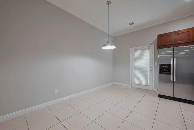 a view of an empty room with a kitchen