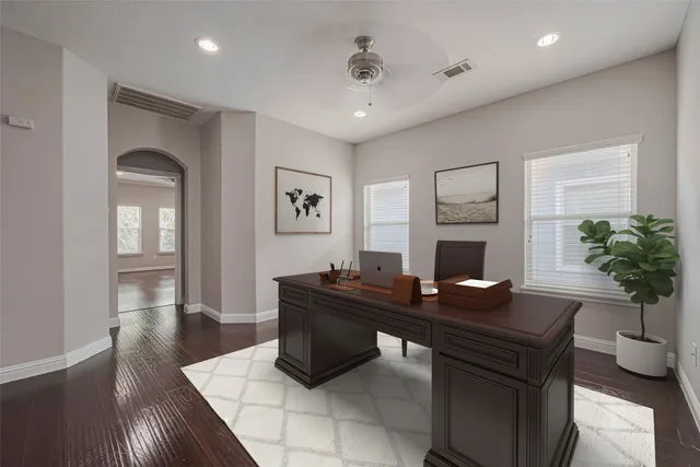 a living room with furniture a fireplace and a potted plant