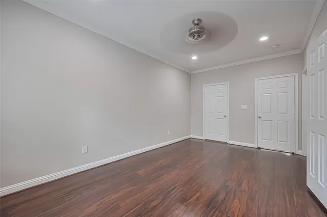 a view of an empty room with wooden floor