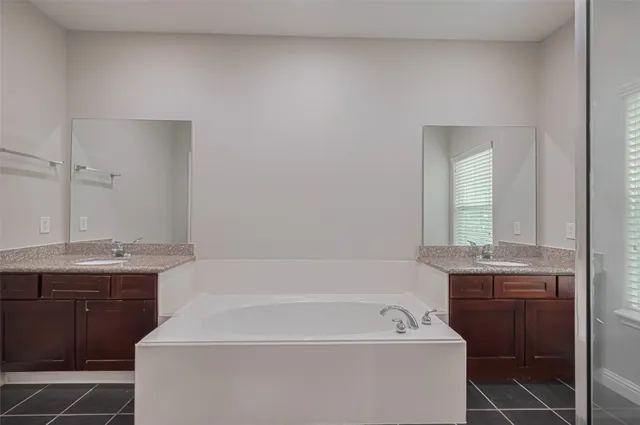 a bathroom with a granite countertop sink a toilet and bathtub