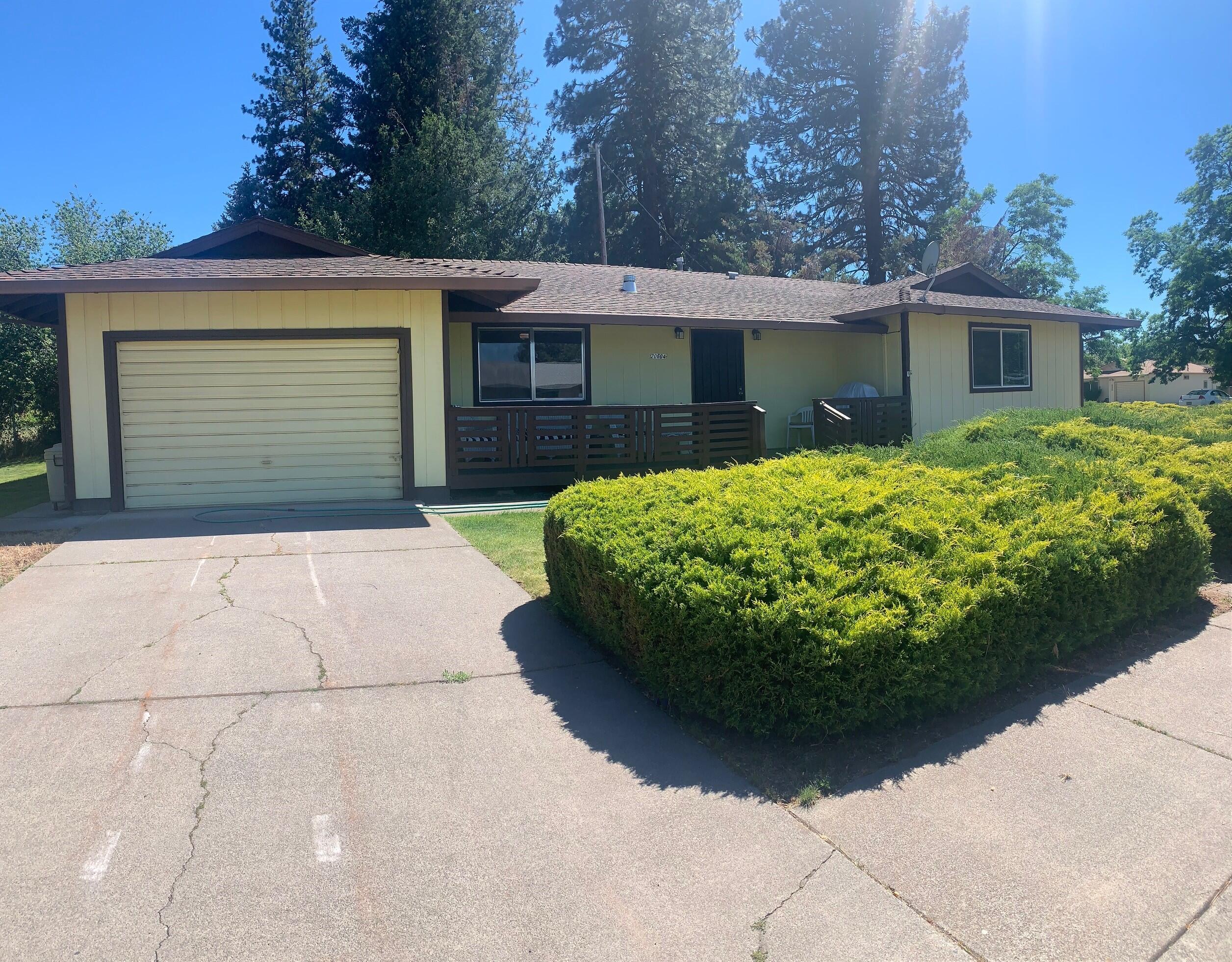 a view of a house with a yard and garage