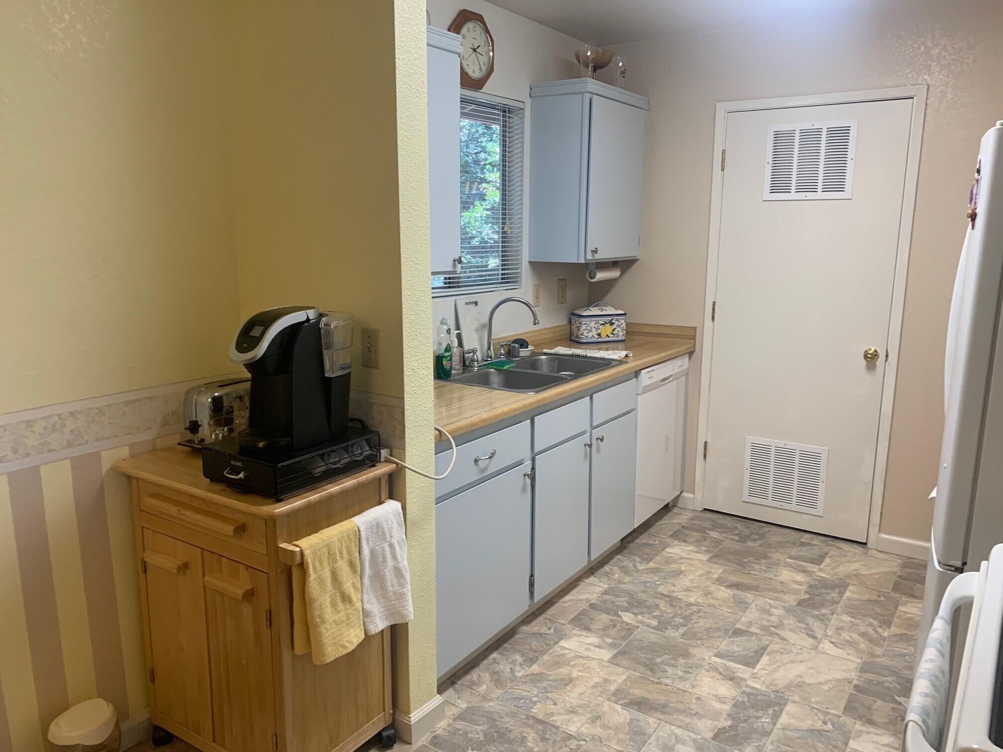 20604 Roff Way Burney, CA 96013 - Photo 11 of 32 a kitchen with a stove a sink and a refrigerator