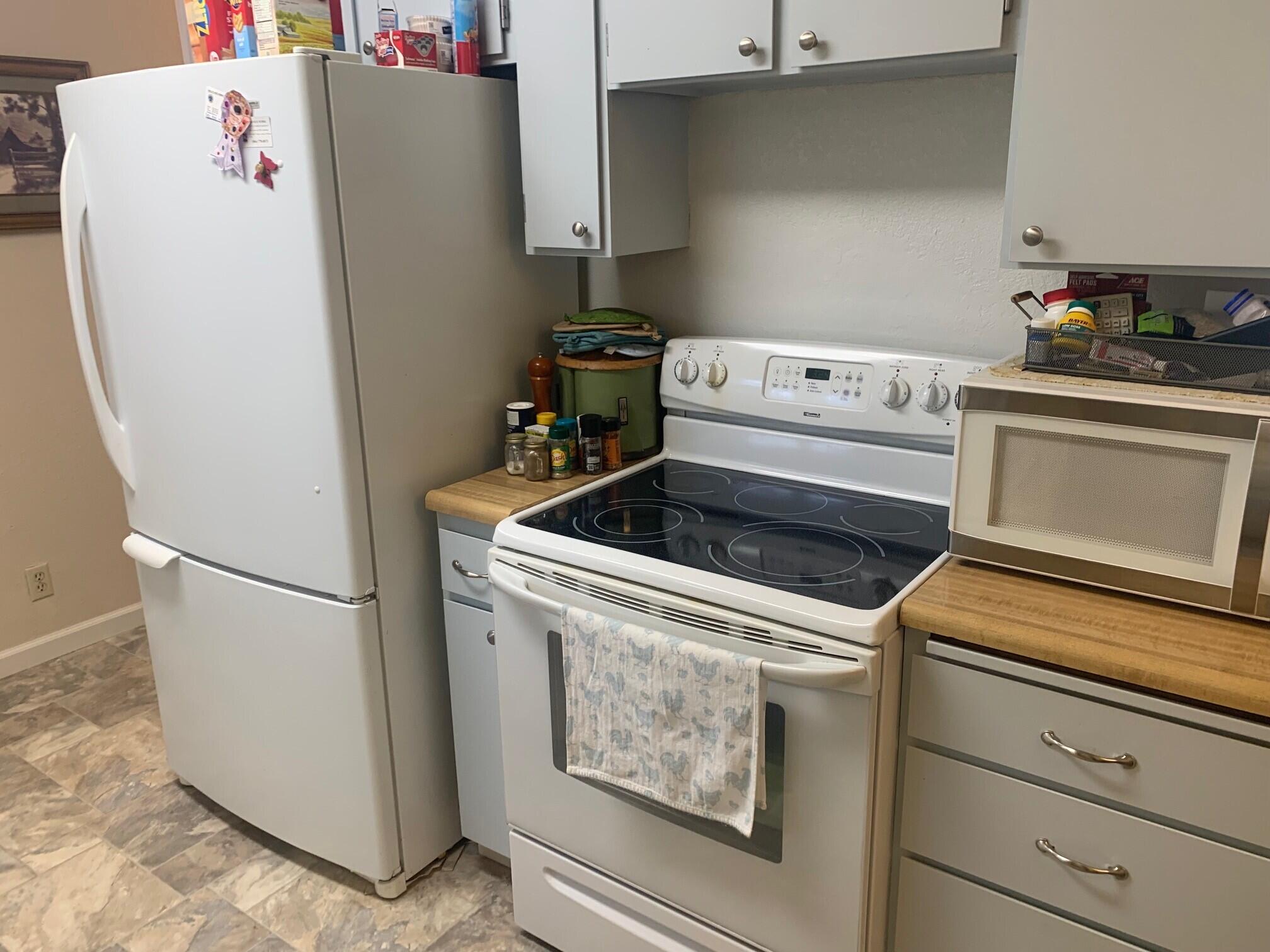 20604 Roff Way Burney, CA 96013 - Photo 12 of 32 a white refrigerator freezer sitting inside of a kitchen
