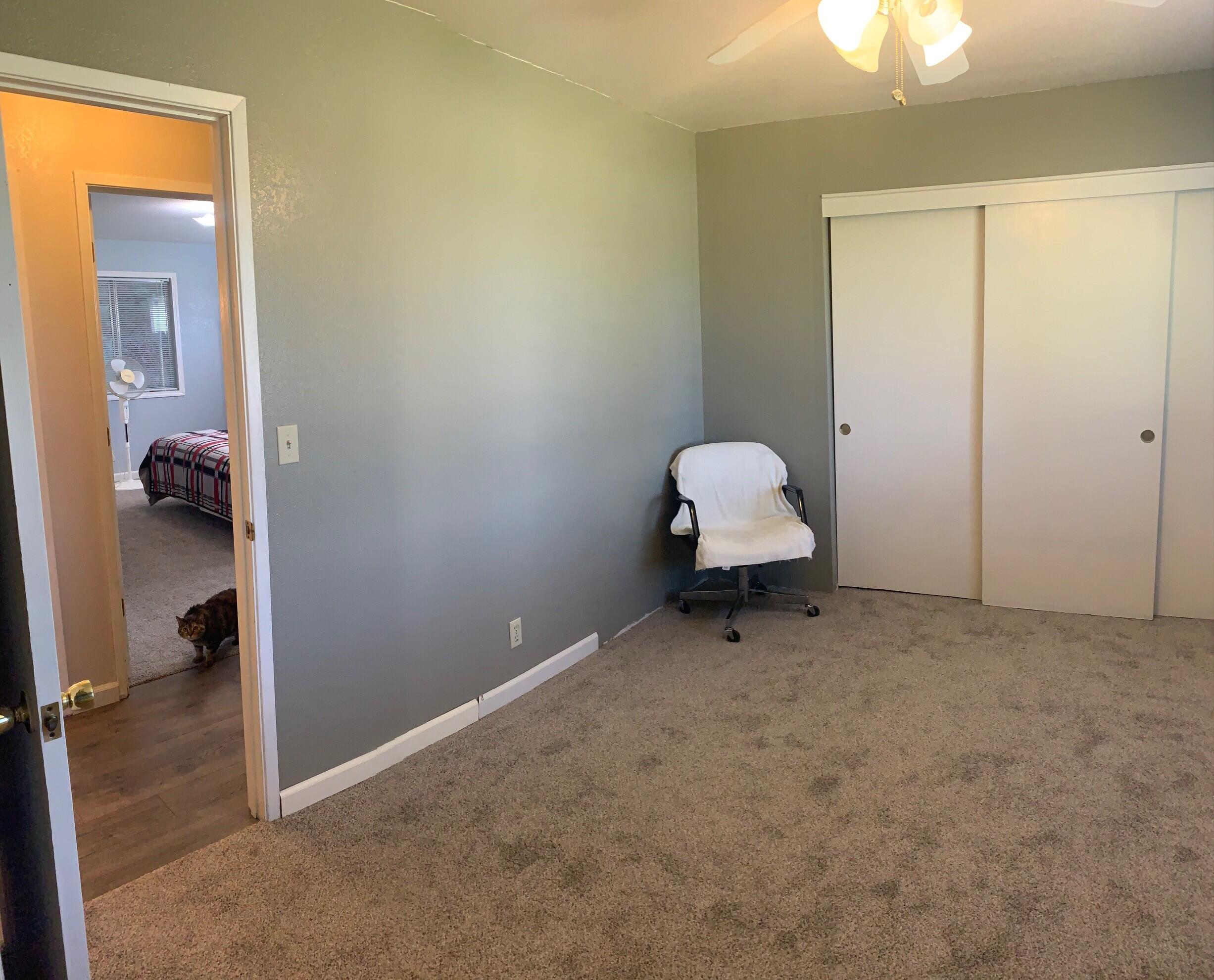 20604 Roff Way Burney, CA 96013 - Photo 19 of 32 an empty room with a chair and a ceiling fan
