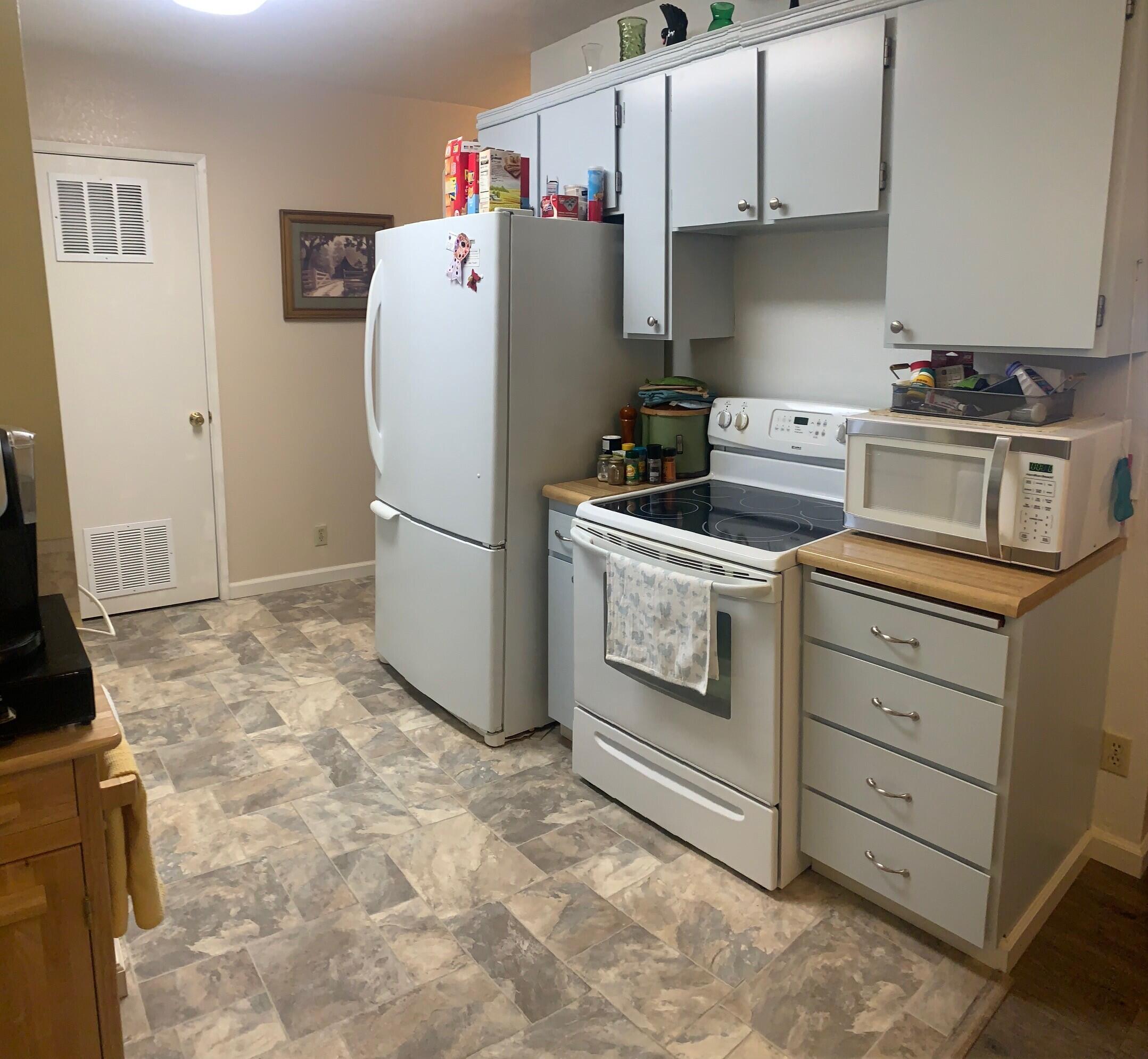 20604 Roff Way Burney, CA 96013 - Photo 2 of 32 a white refrigerator freezer and a stove sitting inside of a kitchen