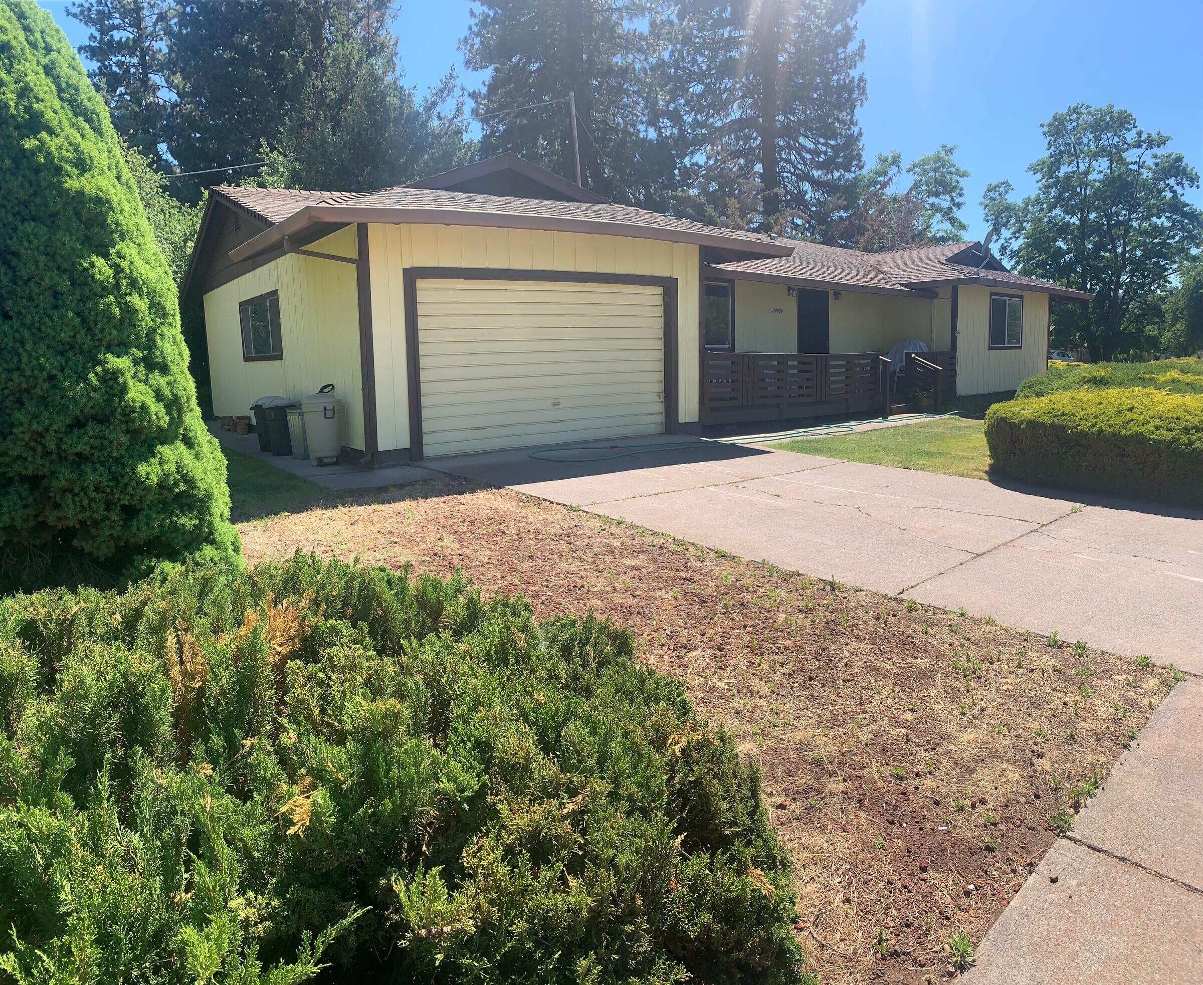 20604 Roff Way Burney, CA 96013 - Photo 28 of 32 a front view of a house with a yard and garage