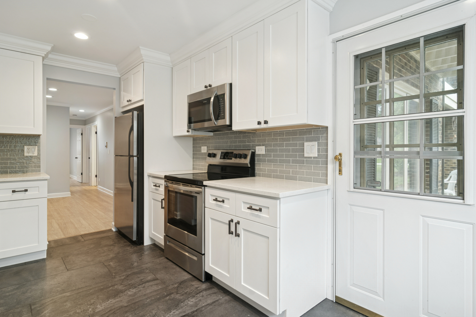 184 Grove Avenue, Unit B Des Plaines, IL 60016 - Photo 11 of 20 a kitchen with stainless steel appliances granite countertop a stove a sink and a refrigerator