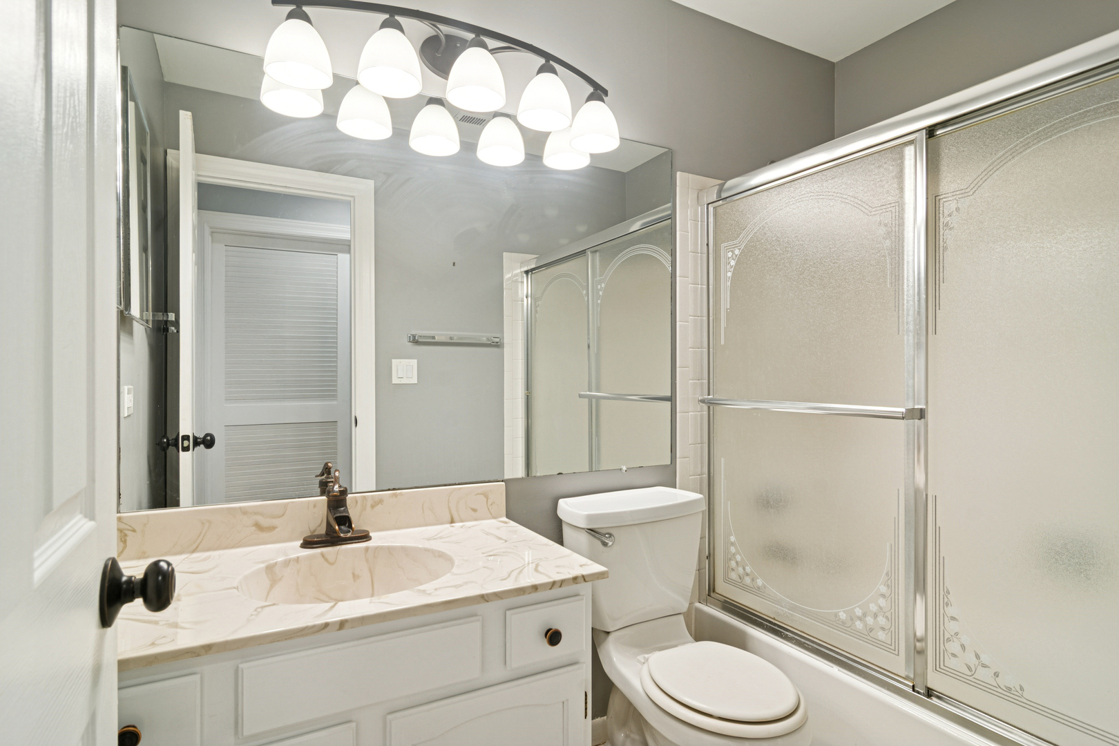 184 Grove Avenue, Unit B Des Plaines, IL 60016 - Photo 12 of 20 a bathroom with a sink toilet vanity and shower