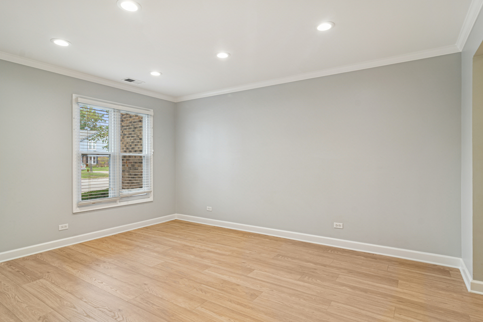 184 Grove Avenue, Unit B Des Plaines, IL 60016 - Photo 13 of 20 an empty room with wooden floor and windows