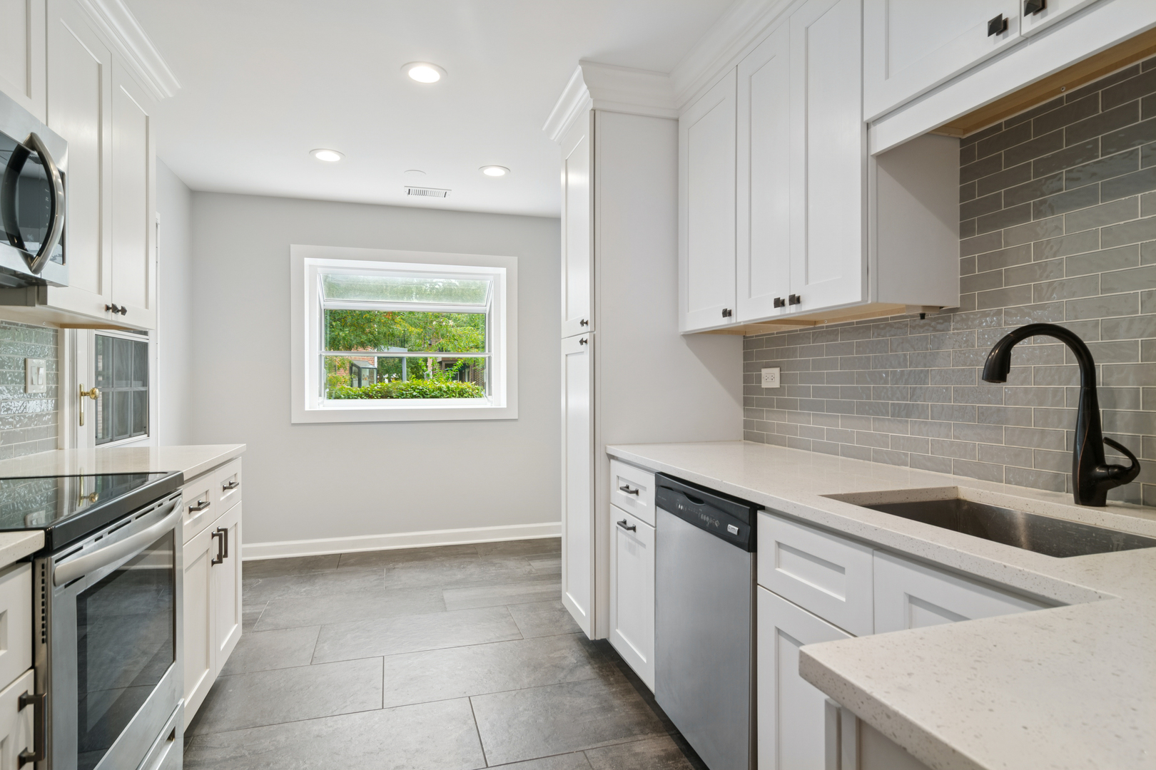 184 Grove Avenue, Unit B Des Plaines, IL 60016 - Photo 8 of 20 a kitchen with granite countertop a stove sink and cabinets